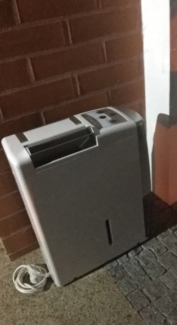 A portable dehumidifier set up to dry a room. Shown on the Dishwasher flood page for Lakeland, FL.