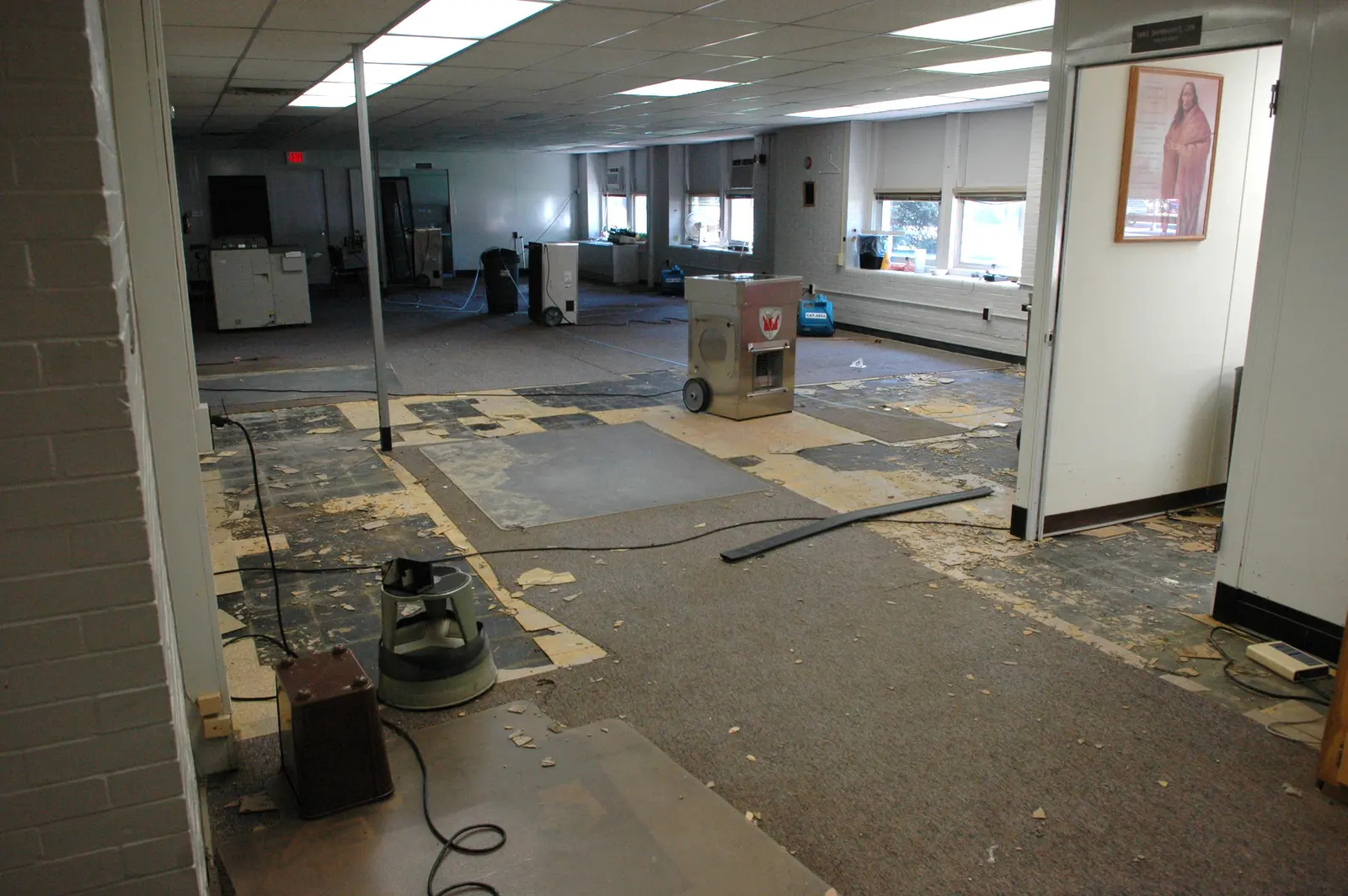 Dehumidifiers and air movers drying a water-damaged room. Shown on area, cost, and FAQ pages for Lakeland, FL.